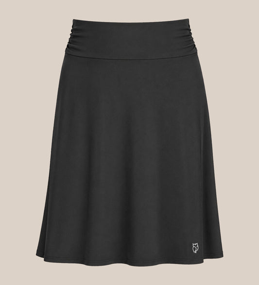 Black OWL skirt layered over leggings, knee-length, shown from the front
